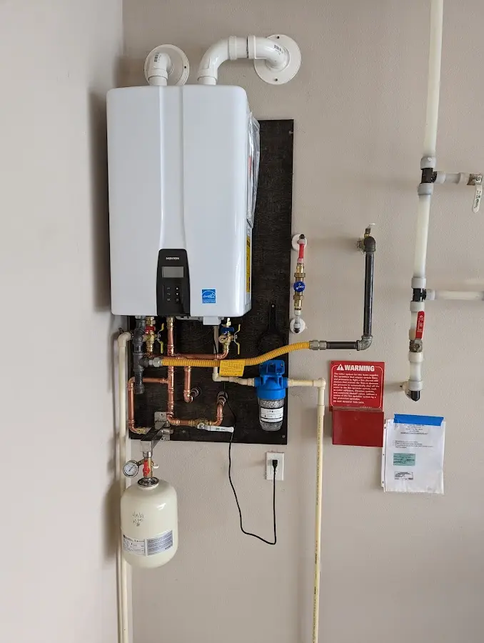 Professional plumber installing copper piping in a Elk City home